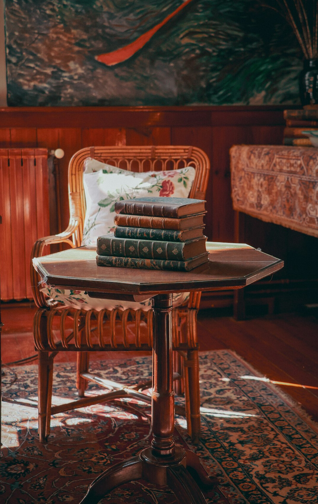 Stack of vintage books on a table in warm light